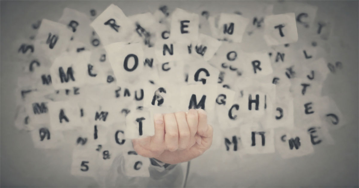 A person holding a card with the words "Profitable Marketing Niches" surrounded by scattered letters