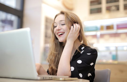 A woman engaged with her laptop in a cozy indoor setting happy with Fiverr results.